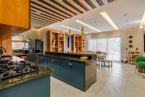 a kitchen with blue cabinets and a stove at Modern village between mountains Villa la Justina in Constanza