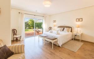 a white bedroom with a bed and a couch at Villa Goreti in Aroeira +31 photos