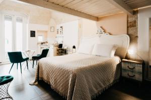 a bedroom with a bed and a table and chairs at Le Contrade Chiasso Cafaro in Monopoli