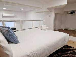 a large white bed in a room with a window at Loft Seco super equipado cerca de metro Pacífico in Madrid