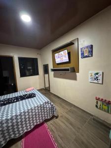 Postel nebo postele na pokoji v ubytování Espaço inteiro - Quarto e cozinha