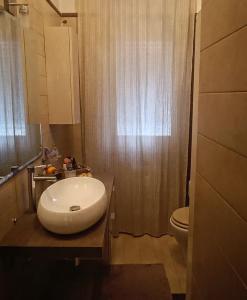 a bathroom with a white sink and a toilet at La Casa di Cristina in Livorno