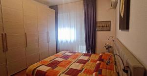 a bedroom with a bed with a colorful quilt at La Casa di Cristina in Livorno