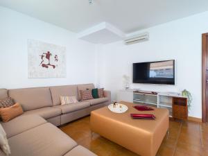 a living room with a couch and a coffee table at Villa Los Olivos in San Bartolomé de Tirajana