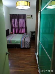 a small bedroom with a bed and a window at Seri Maya -Lrt setiawangsa - Master Room with shared unit in Kuala Lumpur