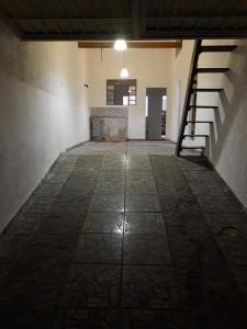 an empty room with a staircase in a building at Casa Indaia Caraguatatuba in Caraguatatuba