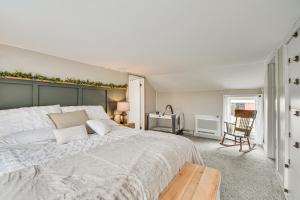 a bedroom with a large bed and a table at Auburn Finger Lakes Farmhouse with Open Views! in Auburn