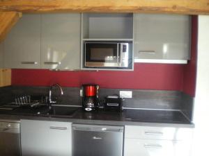 a kitchen with a sink and a microwave at Propriete de 2 chambres avec wifi a Taninges a 7 km des pistes in Taninges