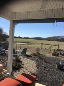 a screened in porch with a view of a field at Donna’s Sunset Meadow in Loudon