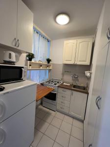 een keuken met witte kasten en een fornuis met oven bij OhMyHome - View Apartment Grzybowska in Warschau