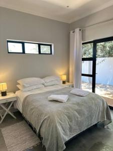 a bedroom with a bed with two towels on it at REst house in Langebaan