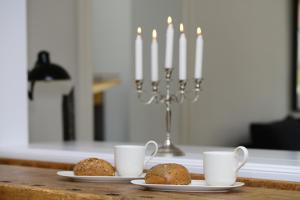 two plates with muffins on a table with two candles at Gesine in Flensburg