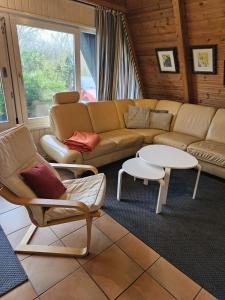 a living room with a couch and chairs and tables at Nordwind in Damp +9 photos