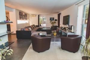 a living room with a couch and a table at Résidence Villa Branda in Calvi