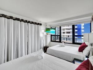 a hotel room with two beds and a large window at Beach Resort condo 921 in Miami Beach +40 photos
