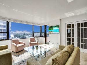 a living room with a couch and a glass table at Beach Resort condo 921 in Miami Beach