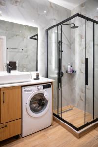 a washing machine in a bathroom with a shower at Kefaloviso Luxury Apartment 2 in Nafpaktos
