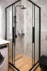 a shower with a glass door in a bathroom at Kefaloviso Luxury Apartment 2 in Nafpaktos +20 photos