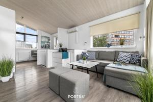 a living room with a couch and a table at Ferienhaus Strandperle Marina Wendtorf in Wendtorf