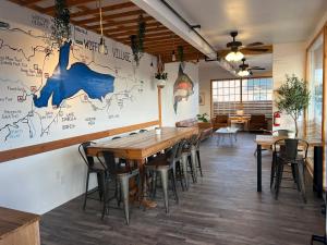 un restaurante con mesas y sillas de madera y un mapa en la pared en Wofford Village Studios en Wofford Heights