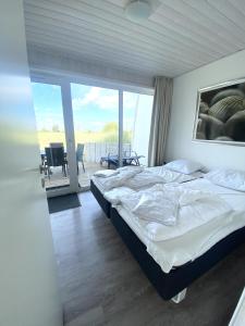 En eller flere senge i et værelse på Ferienhaus Kleine Auszeit Marina Wendtorf