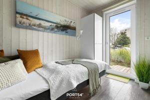 En eller flere senge i et værelse på Ferienhaus Möwe 12 Marina Wendtorf