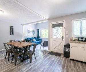 a living room with a table and a blue couch at Indian Point Villa#6 at Tribesman Resort on Table Rock Lake near Silver Dollar City, Branson in Branson