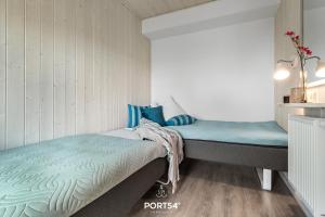 En eller flere senge i et værelse på Ferienhaus Ocean 15 Marina Wendtorf