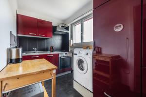 a kitchen with a washing machine and a wooden table at Familienwohnung !Gratis Parken, Free Parking! in Kreuzlingen