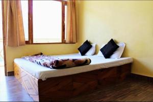 uma cama num quarto com uma janela em Divine blessing em Manali