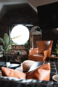 a living room with a leather chair and a table at Trumbull 300 in Detroit
