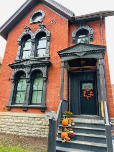 a brick house with pumpkins on the steps at Trumbull 300 in Detroit