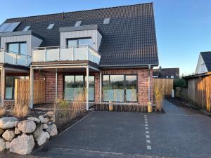 a brick house with a lot of windows at Küste 2 in Büsum +20 photos