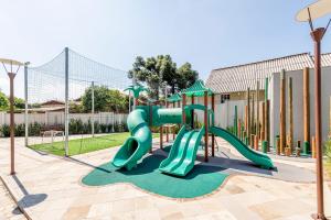 a playground with a slide in a park at Conforto e Aconchego em Gramado 206E in Gramado