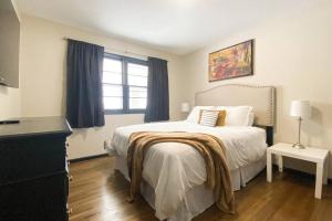 a white bedroom with a bed and a window at King Beds, Sleeps 11, *Entertainment Included!* in Burnsville +37 photos