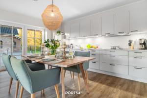 a kitchen with a wooden table and chairs at Lake House in Osterhever