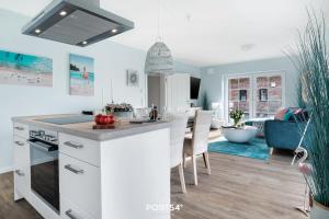 a kitchen with white cabinets and a dining room at Flamingo Bay in Osterhever