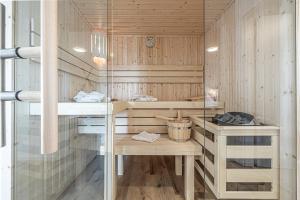 a sauna with wooden walls and a glass wall at Schlei-Koje 1 in Schleswig