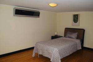 1 dormitorio con 1 cama y aire acondicionado en Apartment Avalon Santa Ana, en Río Oro
