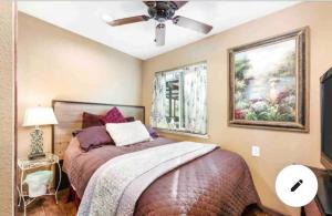 a bedroom with a bed and a ceiling fan at Forest Cottage Large Group Destination Vacation Sleeps 45 in Foresthill