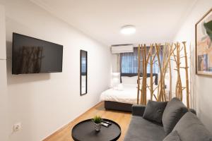 a living room with a couch and a bed at Central Nest in Thessaloniki