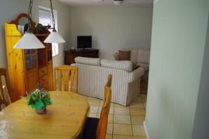 a living room with a table and a couch at Semi-detached house Nordseebrise Niebüll - DNS09100i-L in Niebüll