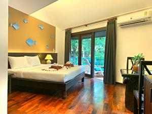 Postel nebo postele na pokoji v ubytování Baan Hin Sai Resort & Spa