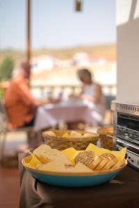 a plate of food on a table with bread at Encosta Azul in Cidade Velha