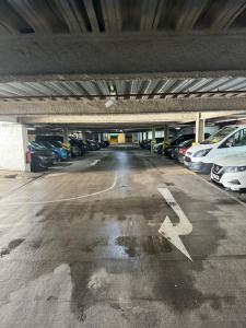 a parking lot with cars parked in a parking garage at Acorn Hotel in Glasgow