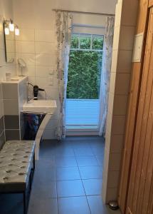 Un baño con lavabo y ventana. en Villa Sienna, en Zingst