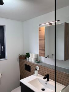 a bathroom with a sink and a mirror at Ferienwohnung Turmblick 