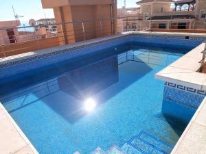 a large blue swimming pool on top of a building at Vista la Mar in Villaricos