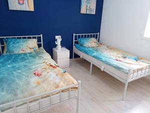two beds in a room with blue walls at Vista la Mar in Villaricos +16 photos