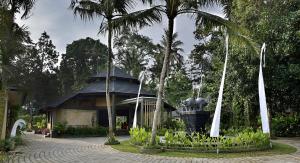 a building with a statue of an elephant in front of it at Gino Feruci Villa Ubud by KAGUM Hotels in Ubud